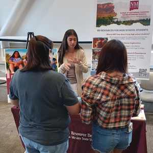 Students at Fair looking at presentation