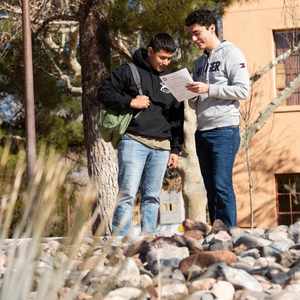 Two students looking at a piece of paper